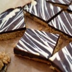 Squares of peanut butter bars topped with chocolate.