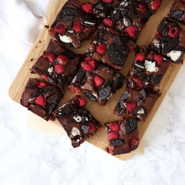 Fudgy, gooey, brownies, with a double layer of Oreos and raspberries. Because fresh fruit cancels out the chocolate, right?! A delicious birthday cake, piled high on a plate or a dessert, served with vanilla ice cream. https://fatburn.news