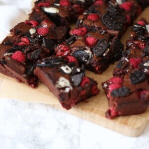 Fudgy, gooey, brownies, with a double layer of Oreos and raspberries. Because fresh fruit cancels out the chocolate, right?! A delicious birthday cake, piled high on a plate or a dessert, served with vanilla ice cream. https://fatburn.news