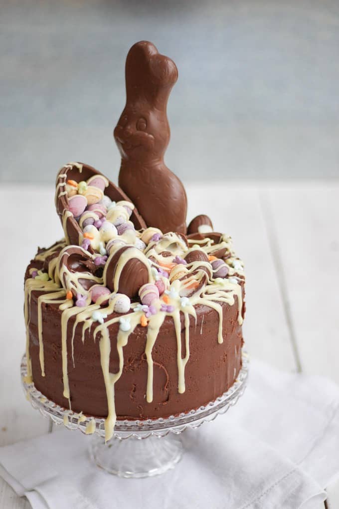 The Ultimate Easter Chocolate Cake! Overload on Easter treats in this decadent, delicious and rich Easter chocolate cake. Topped with Cadbury's Creme Eggs, Mini Eggs, white chocolate drizzle, bunnies and Caramel Eggs. What more could you need in an Easter dessert?!