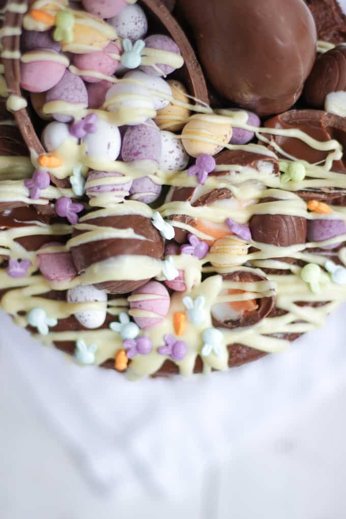 The Ultimate Easter Chocolate Cake! Overload on Easter treats in this decadent, delicious and rich Easter chocolate cake. Topped with Cadbury's Creme Eggs, Mini Eggs, white chocolate drizzle, bunnies and Caramel Eggs. What more could you need in an Easter dessert?!