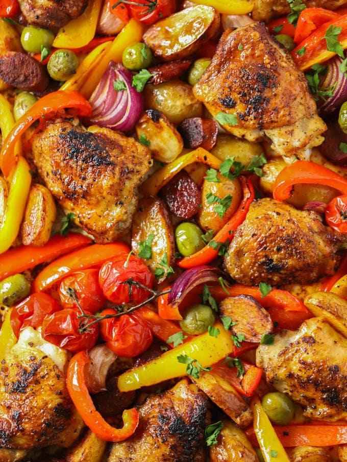 Easy spanish chicken and chorizo tray bake recipe sprinkled with parsley, cooked and ready to serve.