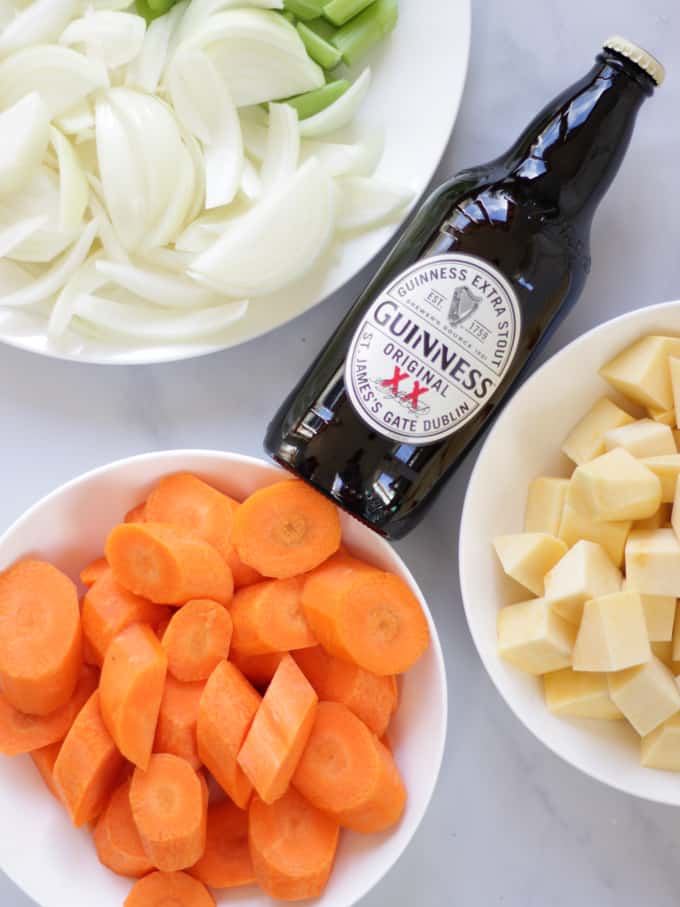 Overhead shot of Guinness and vegetables ready for stew.