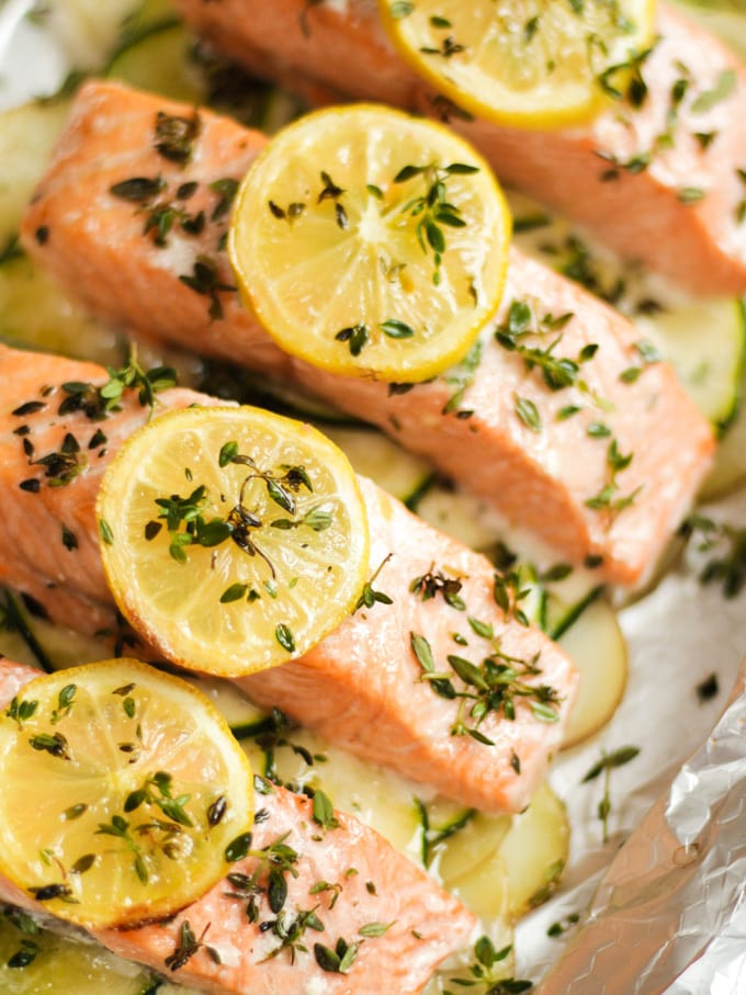 Overhead photo of baked salmon fillets with lemon on top.