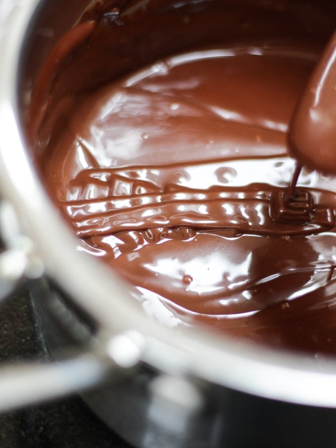 Saucepan of chocolate ganache for chocolate raspberry cake.