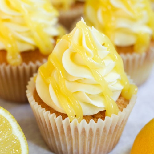 lemon drizzle cupcakes with lemon icing and lemon curd on top.