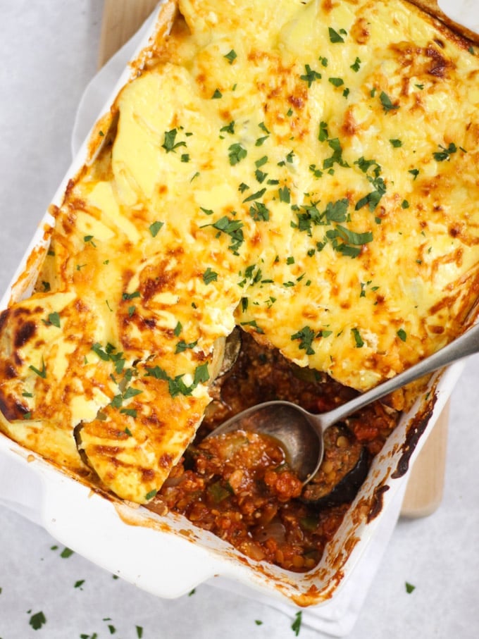 Vegetable Moussaka bake recipe in a white dish with spoon.