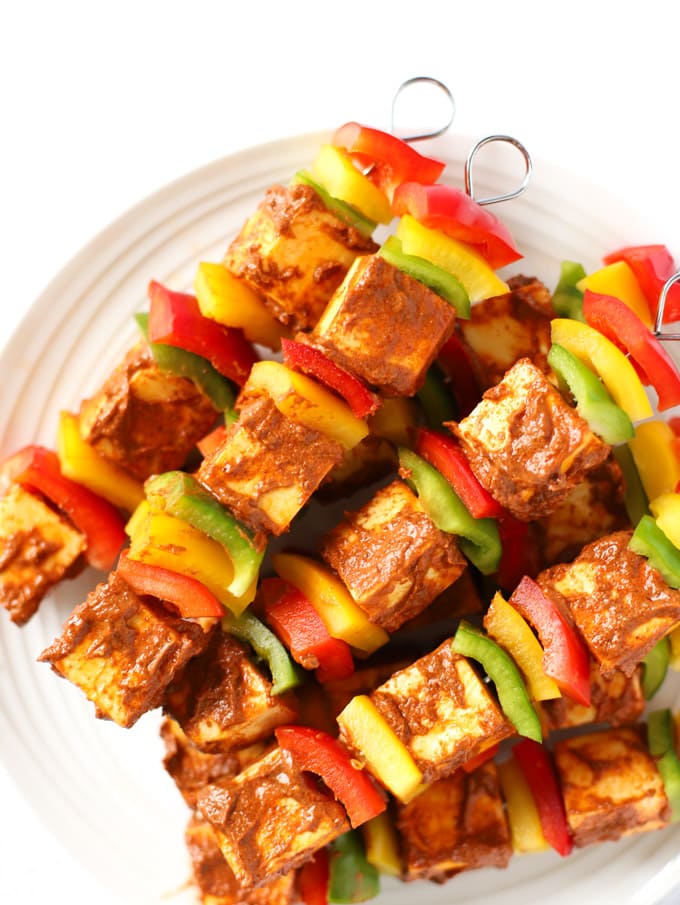 Skewers of spiced peppers and Indian paneer cheese in a heap, ready to cook.