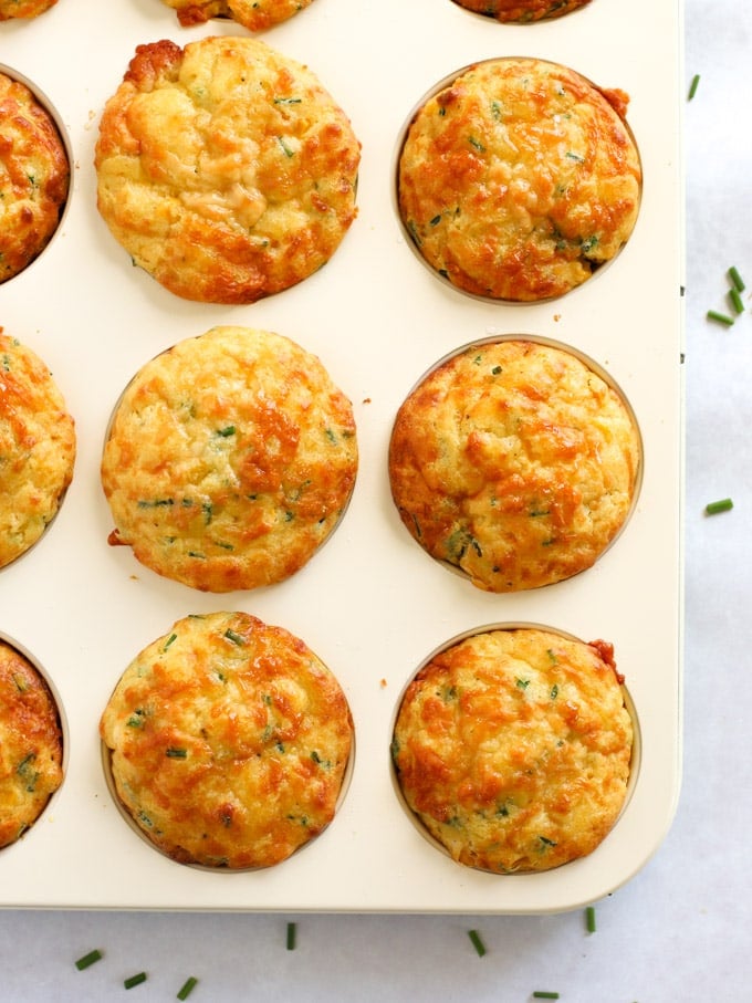 Vegetarian savoury muffins with corn and cheese in a muffin tray.