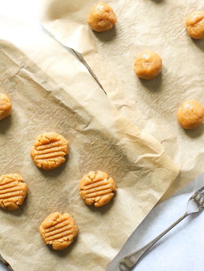 Uncooked Peanut Butter Cookie balls on a baking tray ready to be baked.