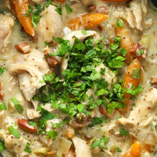Easy slow cooker chicken casserole with bacon and carrots sprinkled with parsley