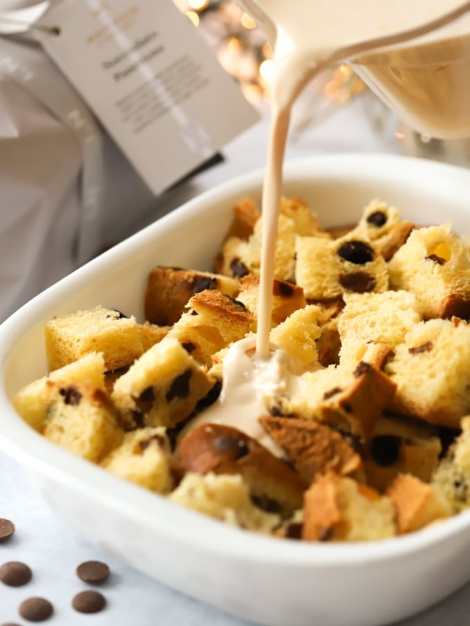 How to make panettone bread and butter pudding, cubes of dry sweet bread with egg mixture pouring on.