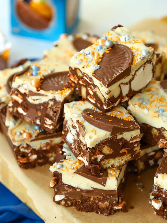 Chocolate Orange Rocky Road squares in a pile, showing the chocolate, marshmallow and biscuit filling.