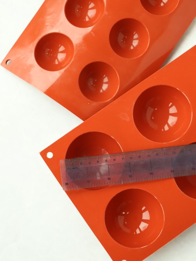 Orange silicone sphere moulds ideal for making Hot Chocolate Bombs.