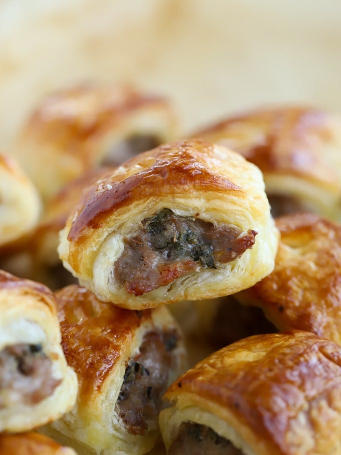 Close up of the edge of a sausage packed pastry rolls.