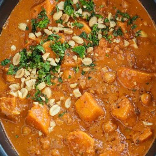 Chunks of sweet potato and chickpeas in a slow cooker sauce in a peanut butter slow cooker vegan stew.