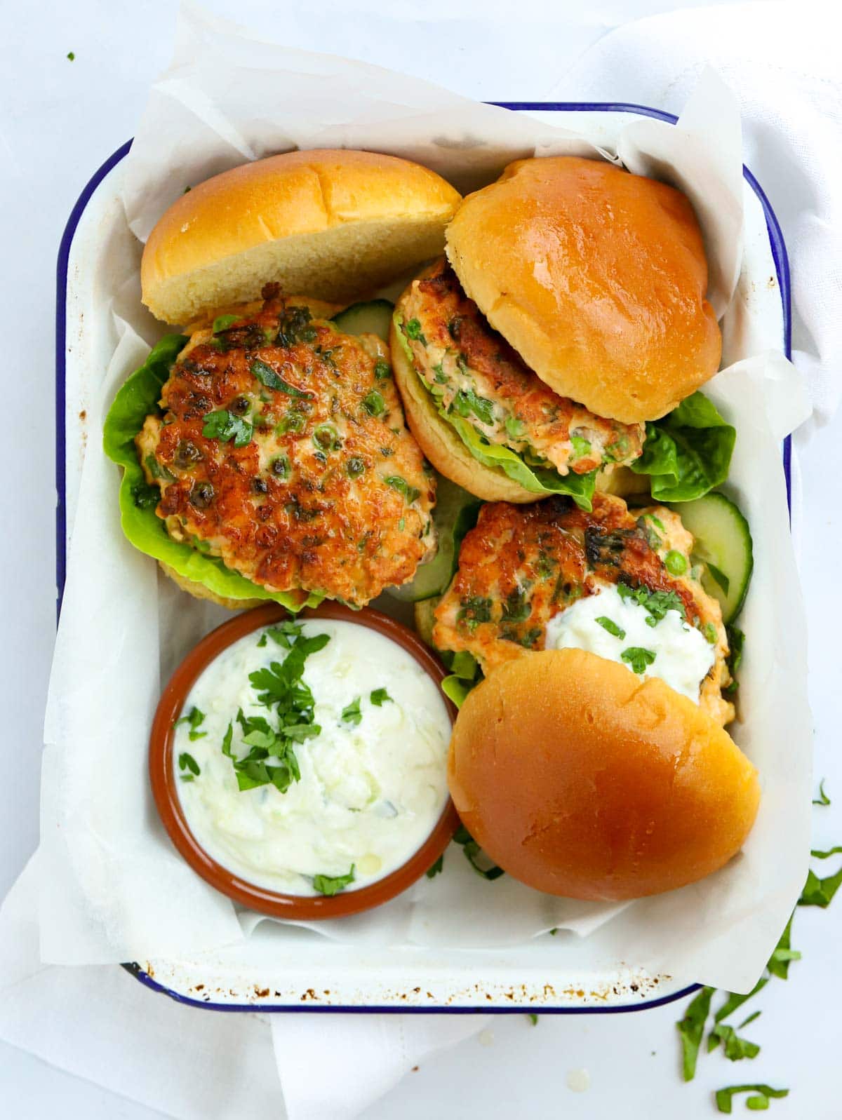Salmon Burgers that have been homemade with a dressing.