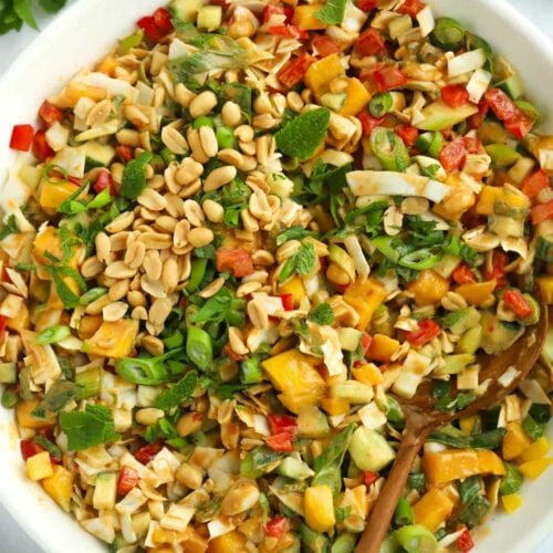 Salad with peanuts, mango, cabbage, peppers and cucumber.