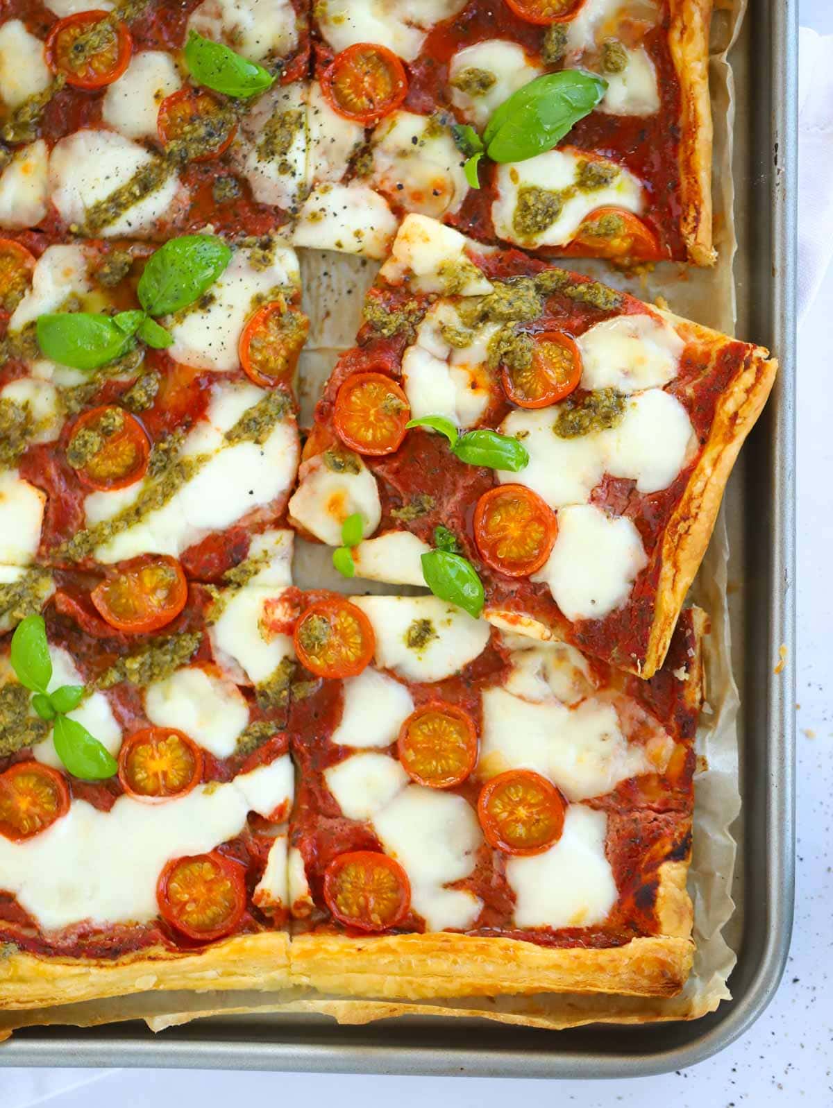 A cheat's pizza made with puff pastry as a base, made with mozzarella and tomatoes.