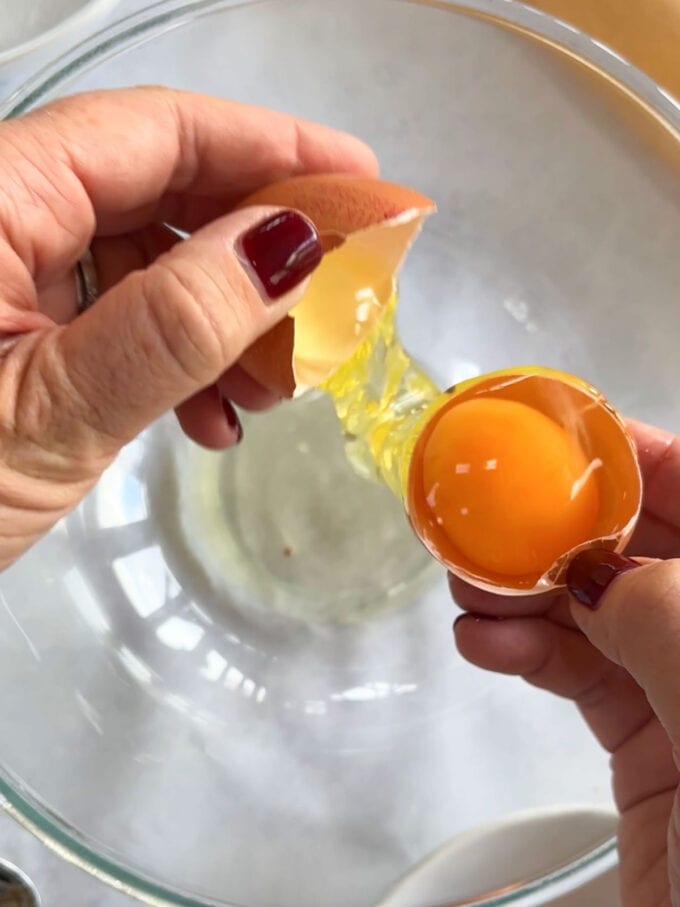 Demonstration of separating egg whites and yolk for the recipe Christmas Wreath Pavlova.