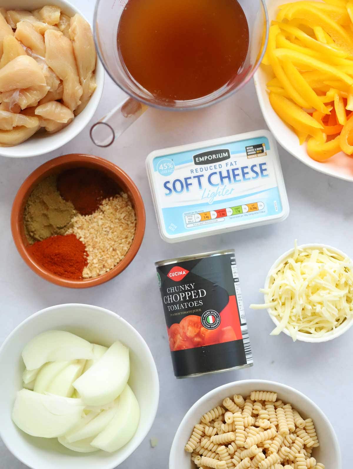 Ingredients for Chicken Fajita Pasta Bake recipe laid on a counter.