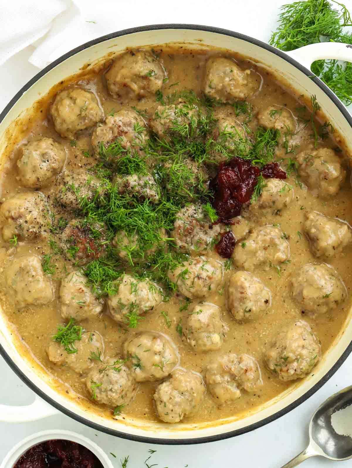 A big bowl of freshly prepared Homemade Swedish Meatballs in a creamy sauce.