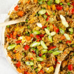 Big bowl of Egg Fried Rice, with spring onion and mixed vegetables.