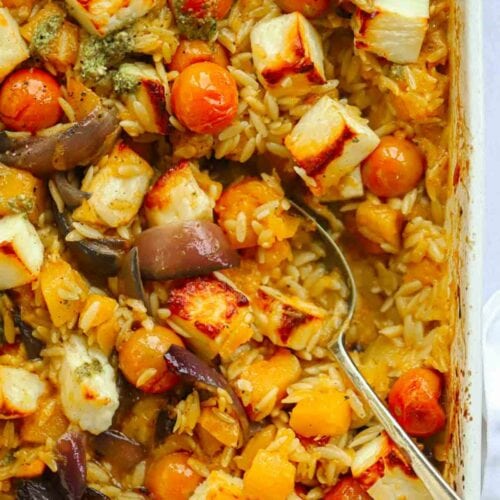 Roasting dish filled with cooked halloumi, tomatoes, onion and butternut squash, cooked and ready to serve.