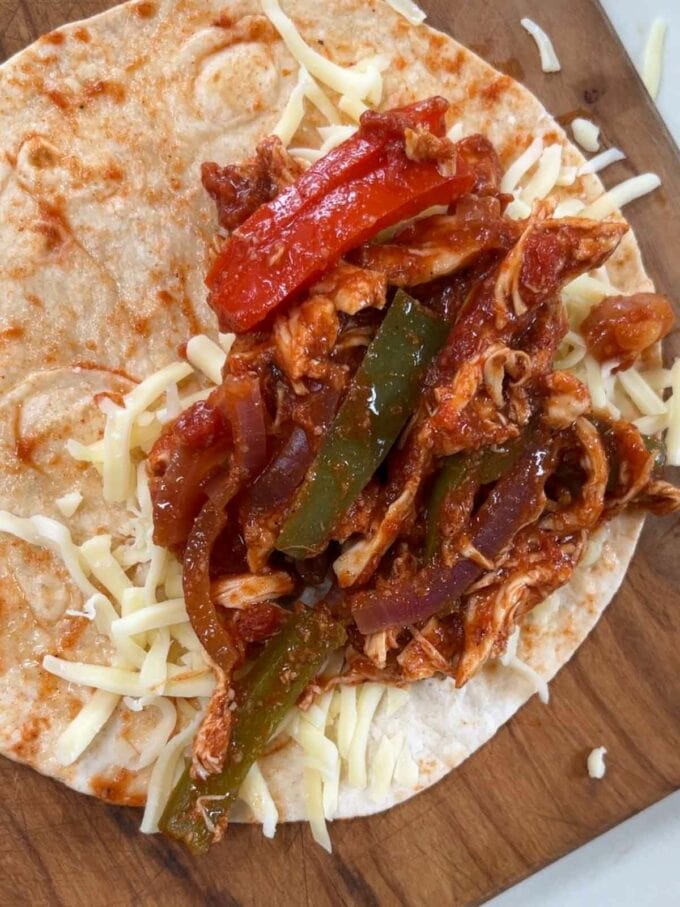 Chicken mixture and cheese to one side of a tortilla.