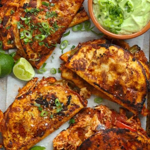 Fried chicken tacos with a creamy dip in a bowl.