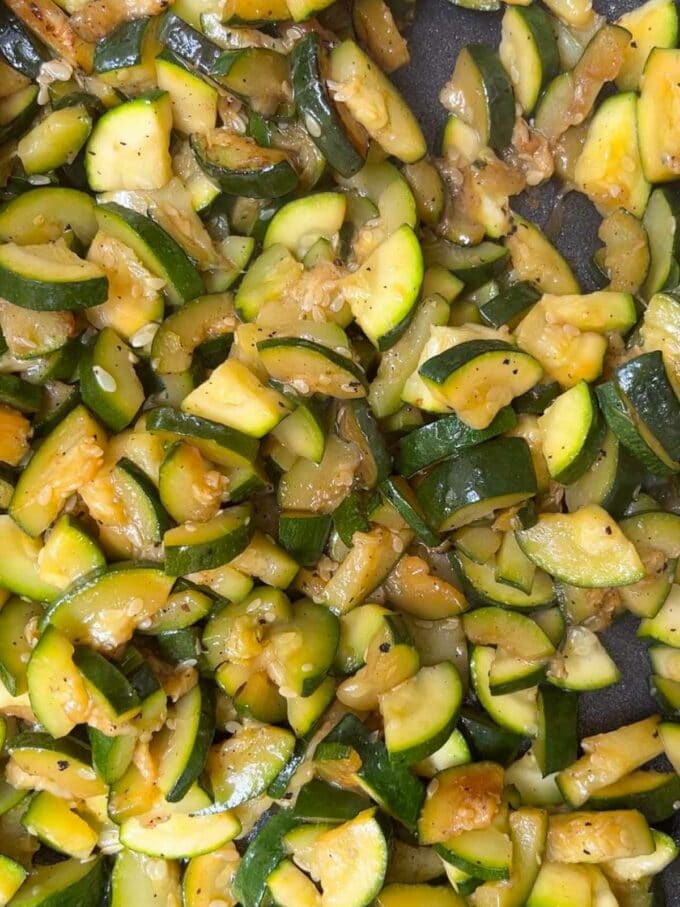 Chopped courgettes cooking in a pan.