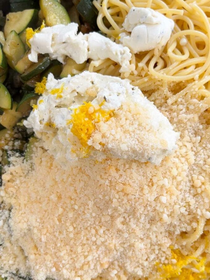Ingredients spaghetti, courgettes, cream cheese and parmesan, ready to be stirred together.