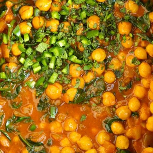 Slow cooker chickpea and spinach curry ready in a pan.