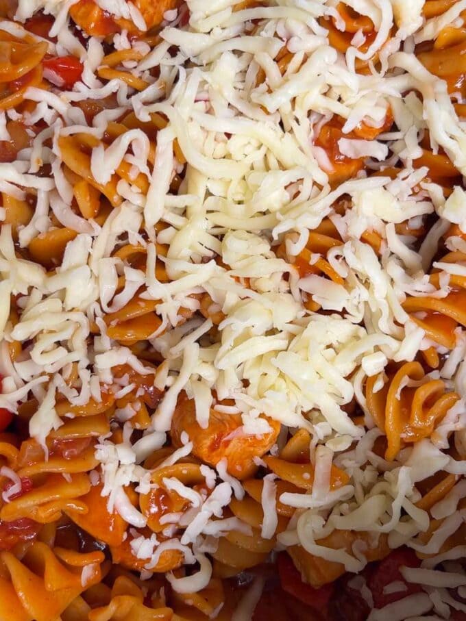 A close up of grated cheese over pasta.