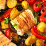 A tray bake of delicious white fish of cod wrapped with pancetta and potatoes and tomatoes.