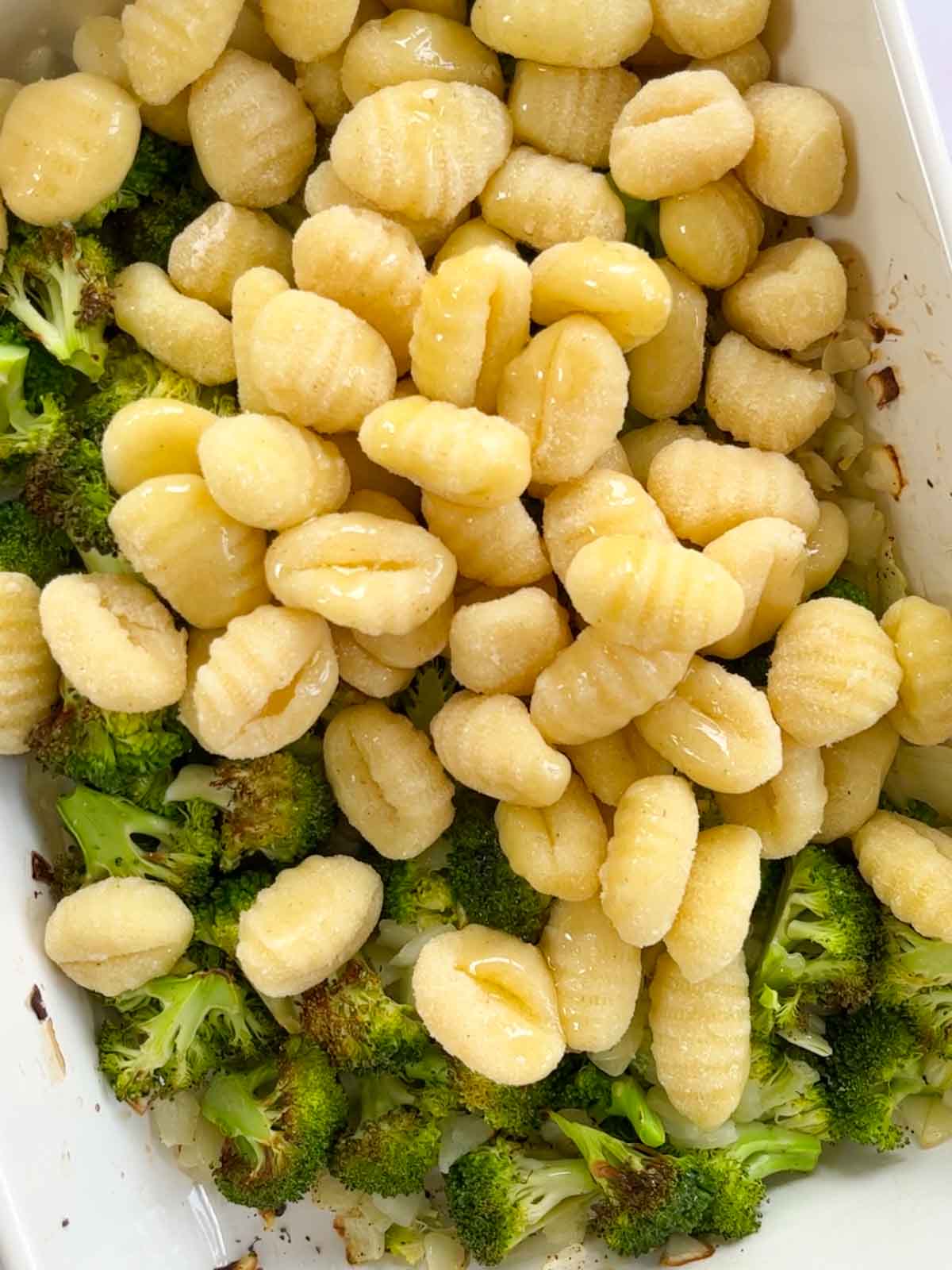 Broccoli and gnocchi in an oven dish together.
