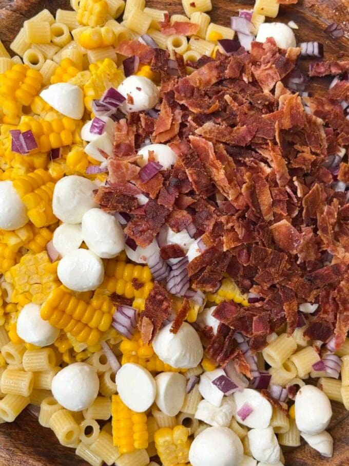 Step 1 in the process of making pesto pasta salad. Cook pasta and chop ingredients.