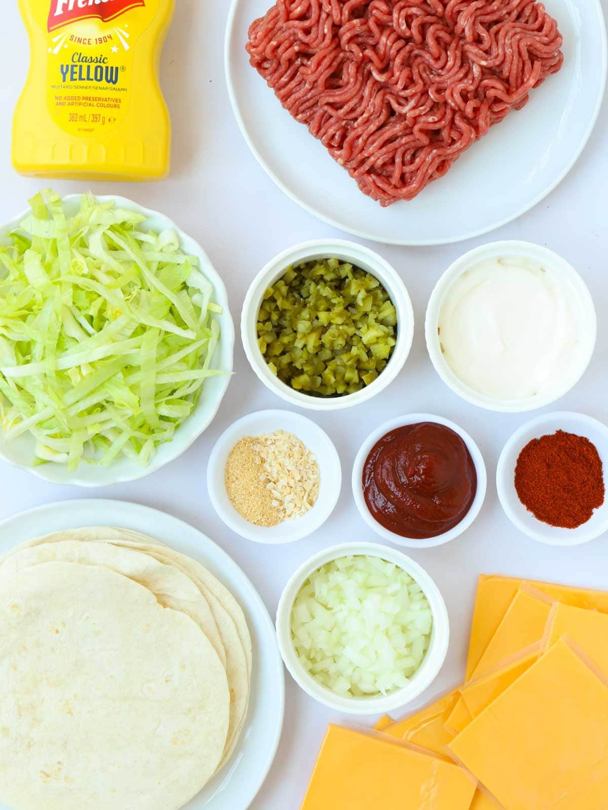 Ingredients laid out on a counter, including mince, tortillas and cheese.