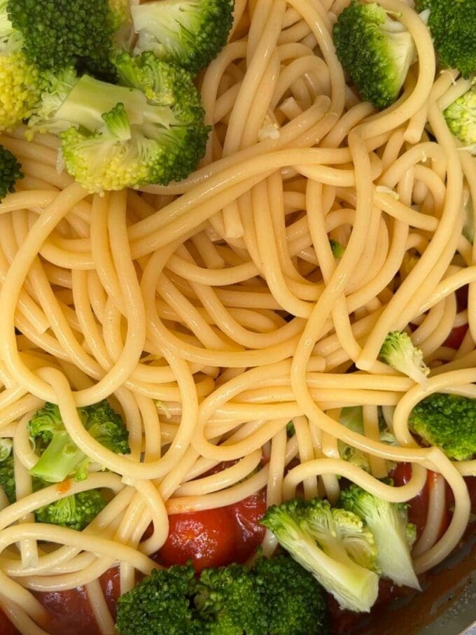 Spaghetti with a tomato sauce, with cubed halloumi and broccoli.