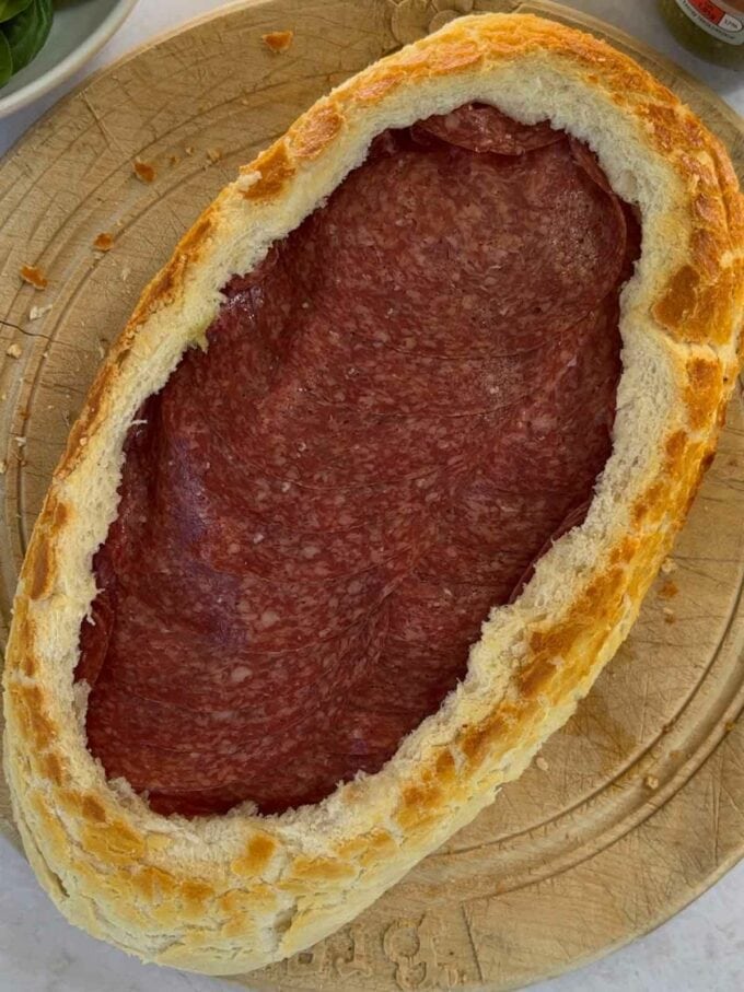 Ham in a hollowed out bread loaf as the next layer in a muffaletta picnic loaf).