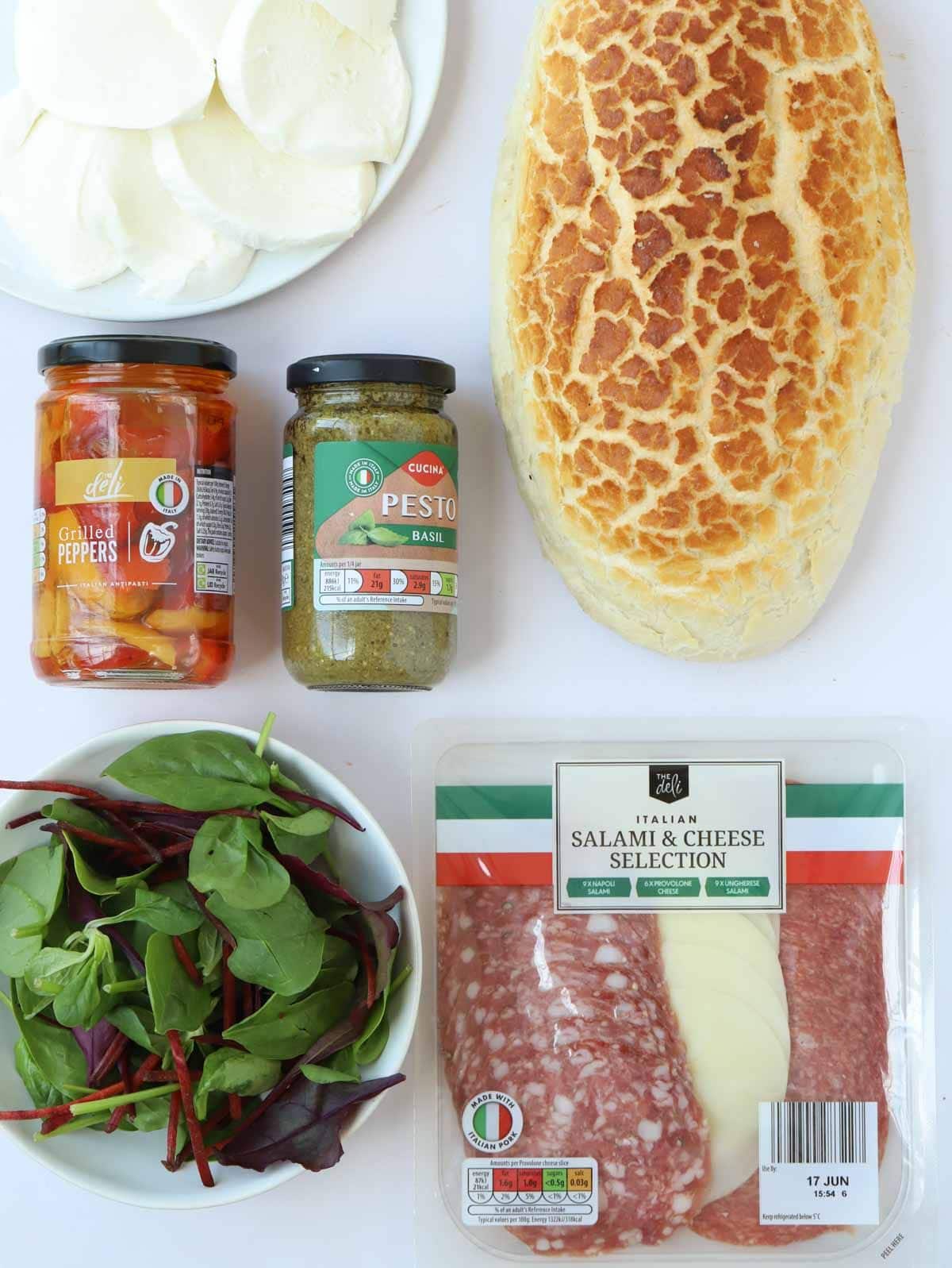 Ingredients for a stuff picnic loaf - AKA muffaletta - laid out on a counter.