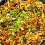 A huge pan of Chicken Chow Mein, with noodles, vegetables and chicken, ready to eat.