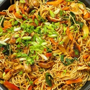 A huge pan of Chicken Chow Mein, with noodles, vegetables and chicken, ready to eat.