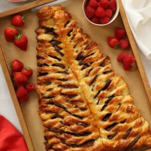 A Nutella Christmas tree, golden and baked with chocolate swirls for a delicious festive breakfast.