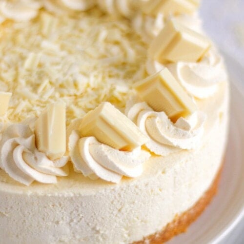 A white chocolate cheesecake on a plate.
