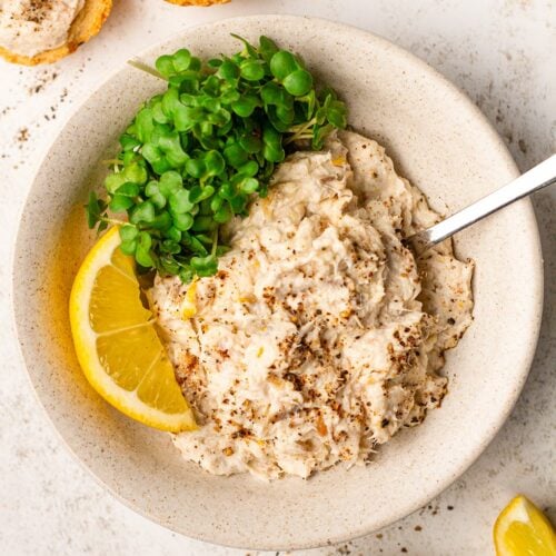 A table with smoked mackerel pate on a plate with salad, and mackerel with toast at the side.