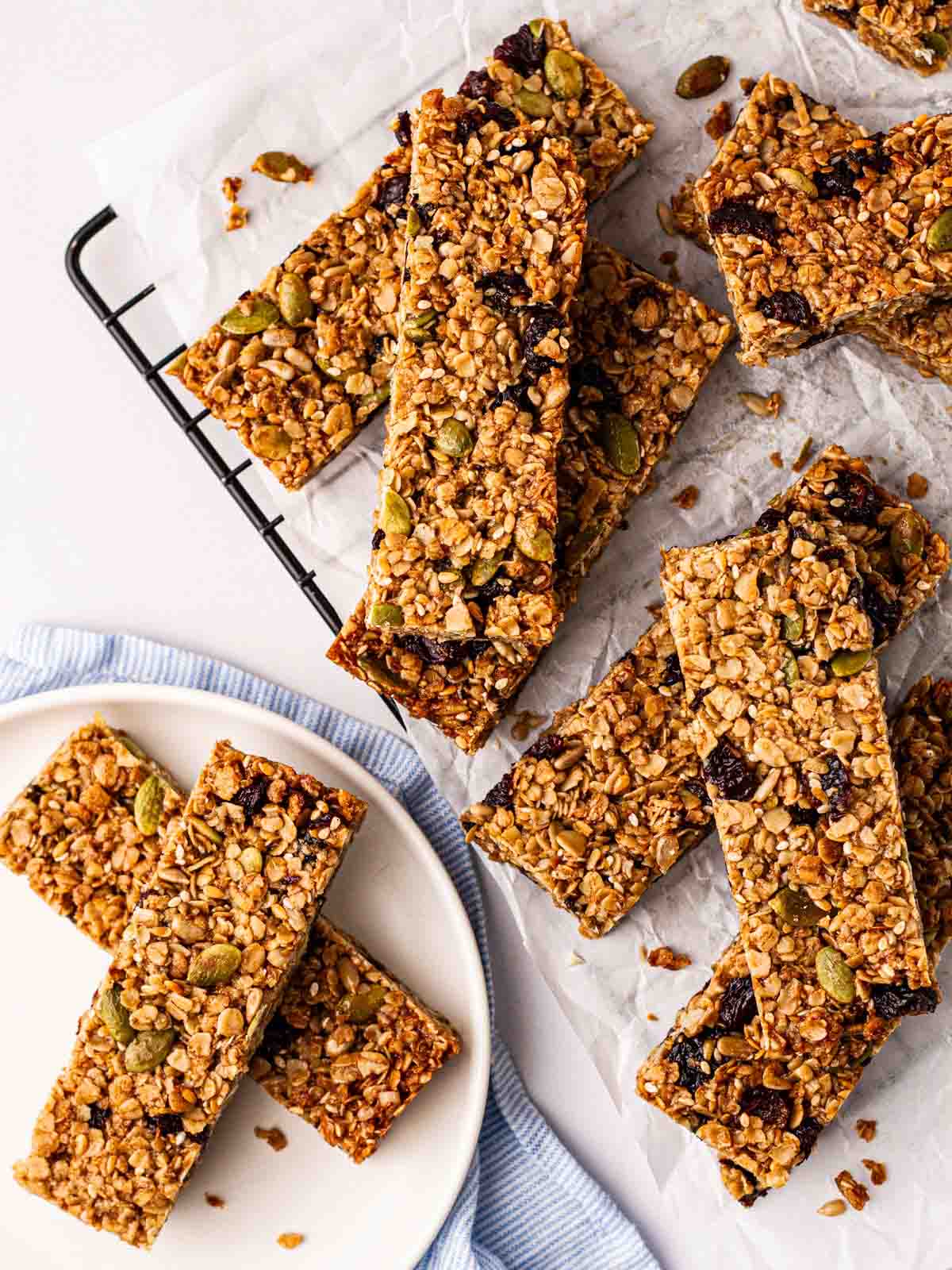 Lots of just-baked granola bars on a wire rack, ready to eat.
