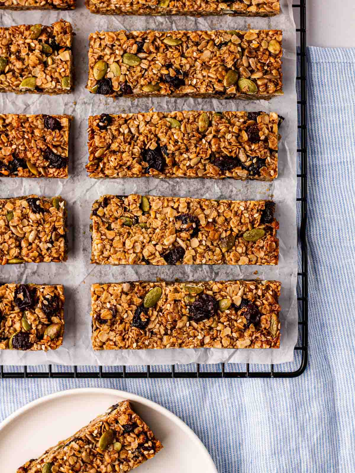 Rows of homemade granola bars on a wire rack after being baked.