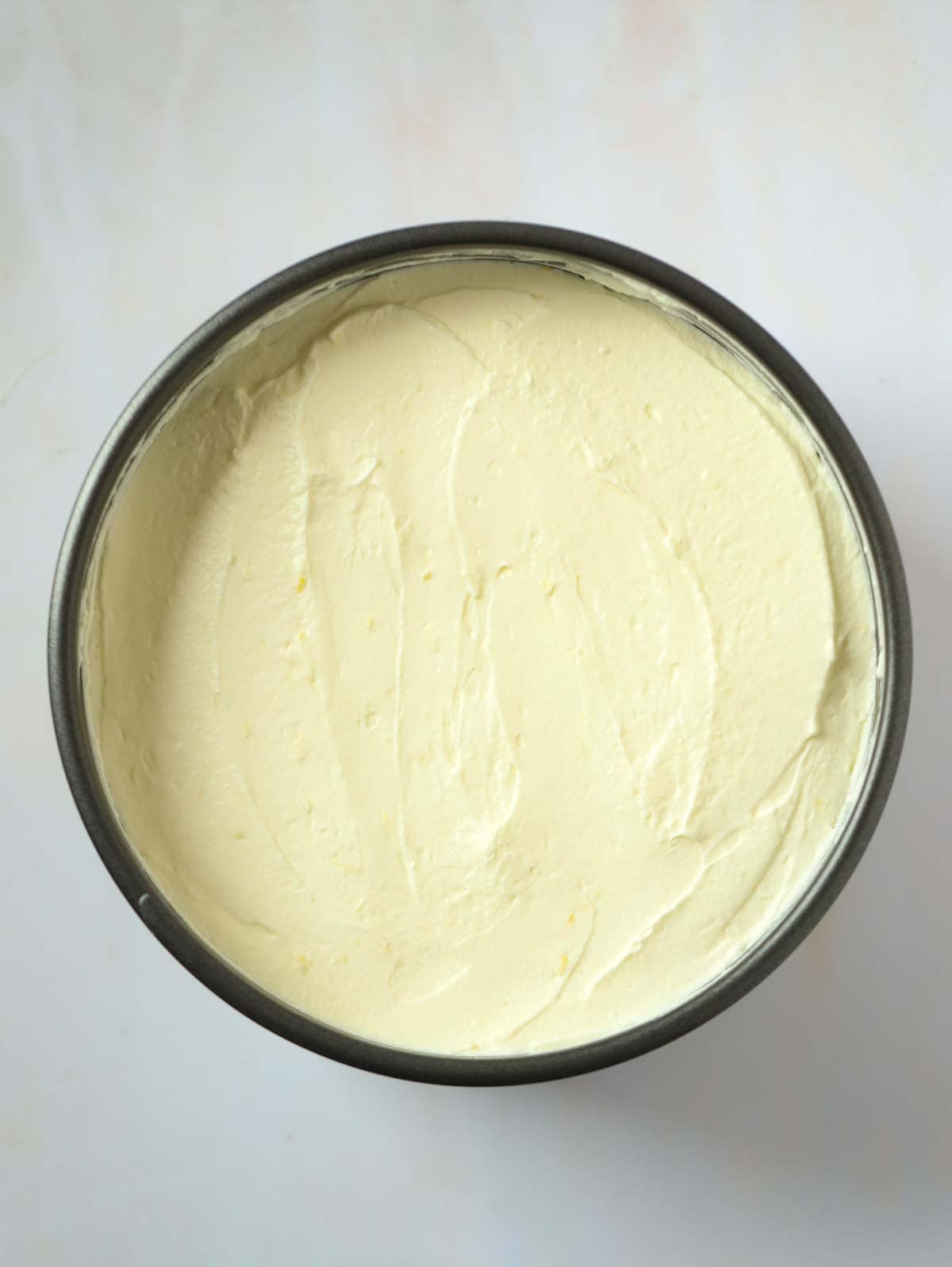 A Lemon Cheesecake still in the tin for step 5 in the recipe.
