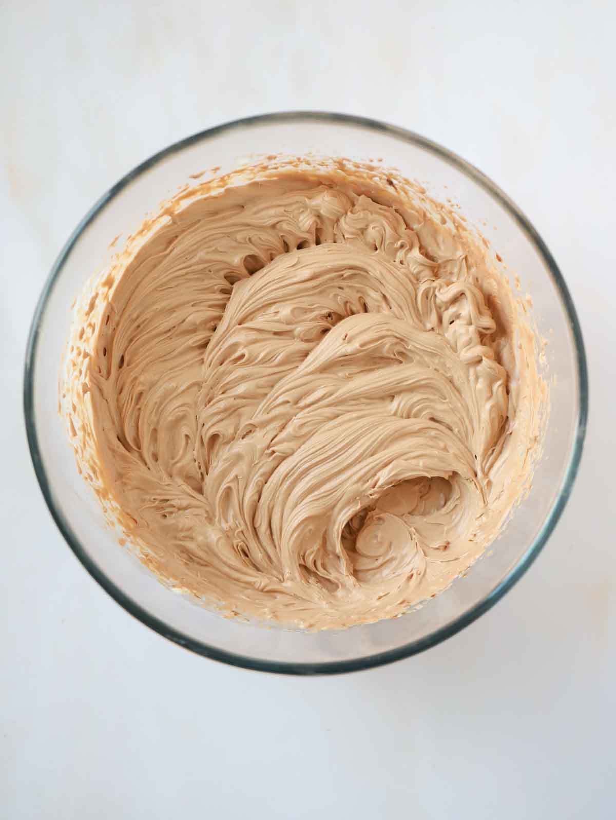 Whipping cream, sugar, cream cheese and lemon juice in a glass bowl for for step 3 in the recipe for Nutella Cheesecake.